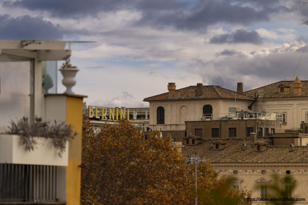 Sunlit historic building with autumn trees in foreground