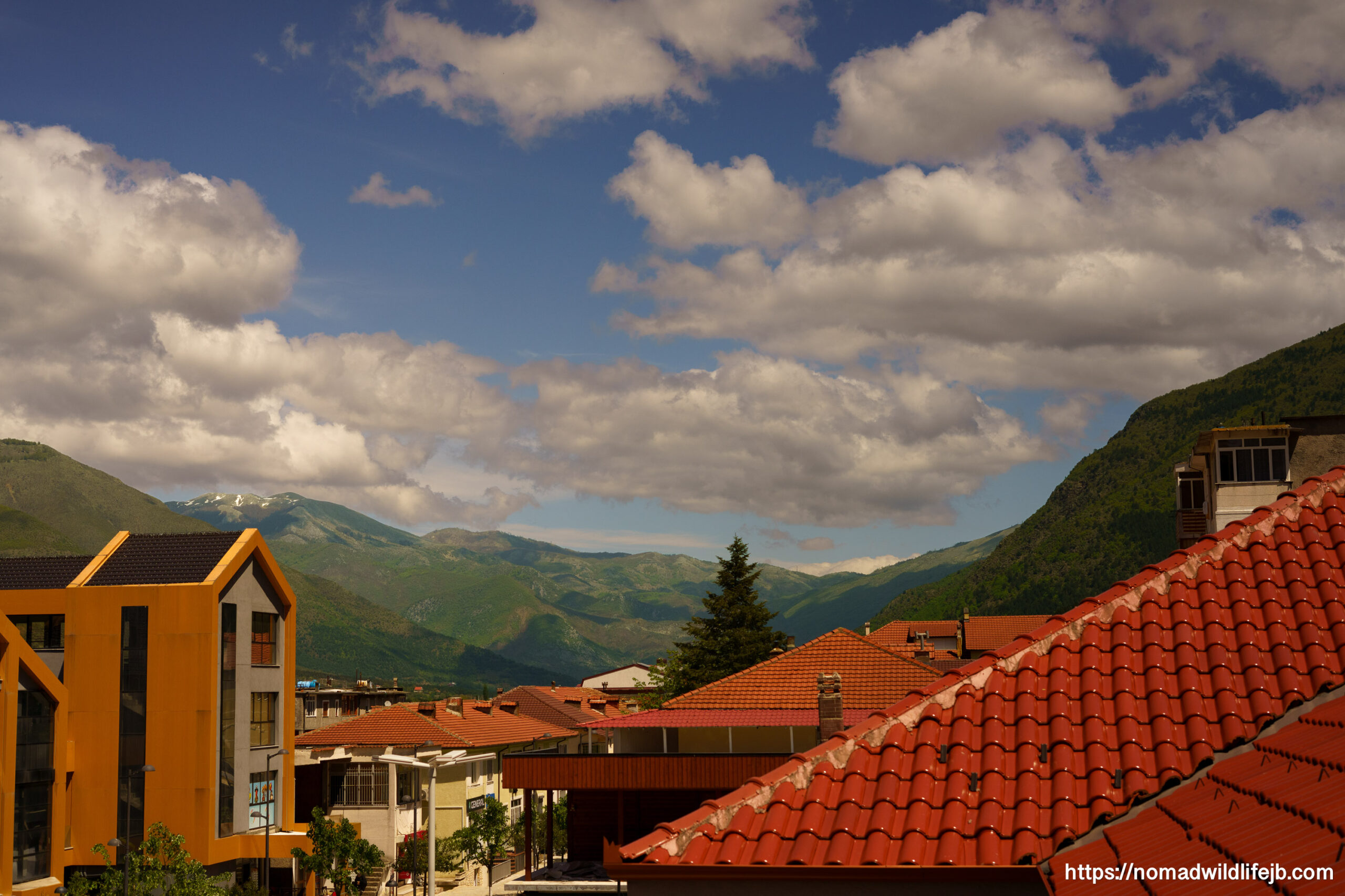 Hotel View Over Bulqizë Red rooftops and mountain views from a hotel in Bulqizë, Albania.