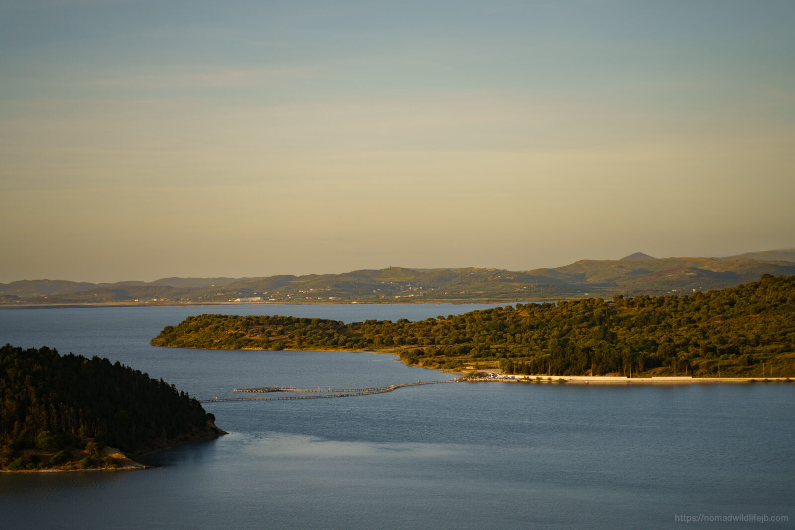 View across the Narta Lagoon and surrounding coastal wetlands near Vlorë, Albania, at sunset.